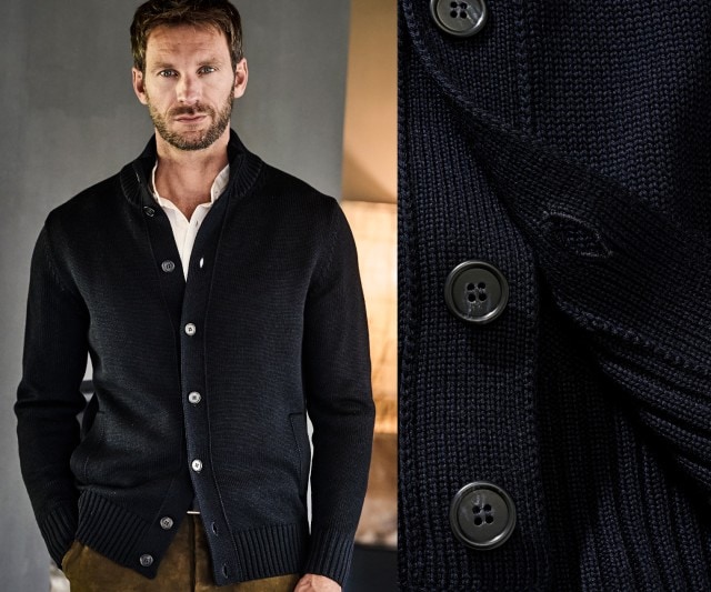 Auf dem Bild ist ein Mann zu sehen, der eine dunkelblaue, grob gestrickte Strickjacke mit Knopfleiste trägt, daneben eine Detailaufnahme der Knöpfe und des Strickmusters.