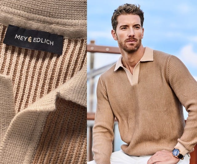 Ein Mann trägt einen beigefarbenen, grob gerippten Strickpullover mit offenem Polokragen in einem etwas helleren Beigeton.