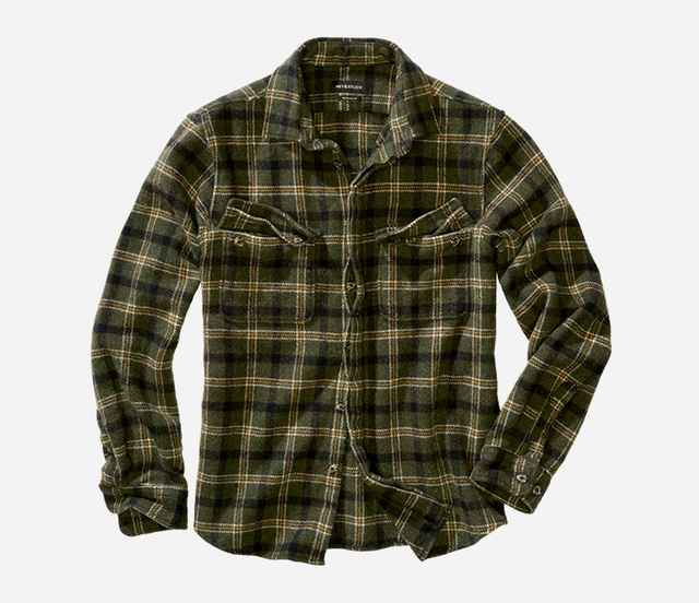 Grün kariertes Flanellhemd mit Brusttaschen und Button-Down-Knöpfen auf hellem Hintergrund, Ärmel leicht hochgekrempelt.